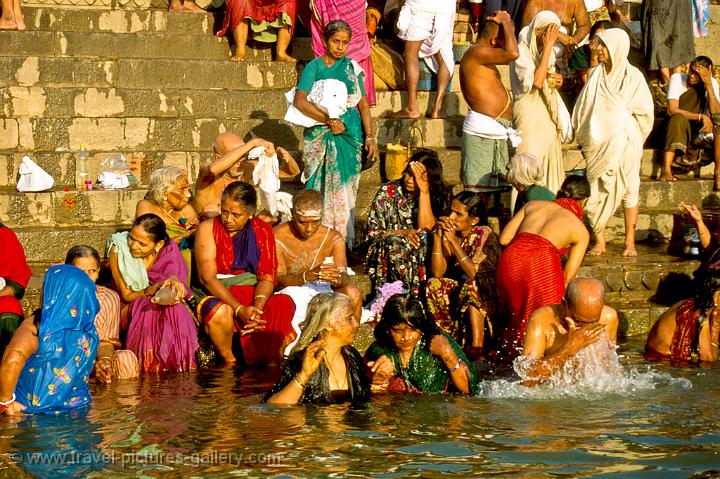 pilgrims taking a ritual bath on the ghats along the Ganges