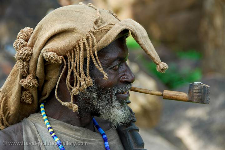 a man of the Dogon People Tribe smoking a pipe
