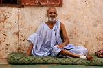 man relaxing outside his house