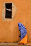 ochre wall and colourful dress