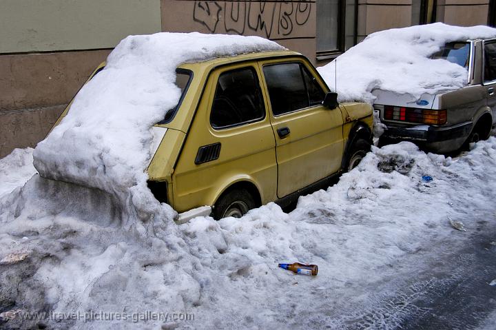 small car under a pile of snow