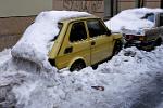 small car under a pile of snow